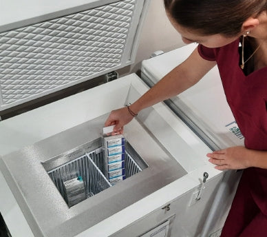 Nurse placing a product inside the TempArmour Vaccine Freezer (Model BFFV15)