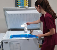 Load image into Gallery viewer, Nurse removing products from the TempArmour Vaccine Refrigerator (Model BFRV84)